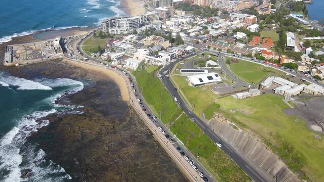 Aerial drone view along the coastal town of Newcastle, NSW, Australia on a sunny day 