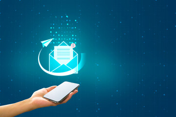 Mobile mail application, communication and mail concept with digital blue envelope with notification alert and paper plane above human hand with modern smartphone on abstract blank background, mockup