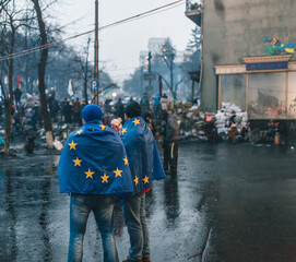 Revolution of Dignity in Ukraine. Two men wearing EU flags during Maidan revolution in 2014