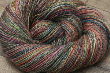 Closeup detail of colourful organic natural handspun and handdyed merino sheep wool yarn , spun on...