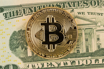 Golden bitcoin coin on dollar