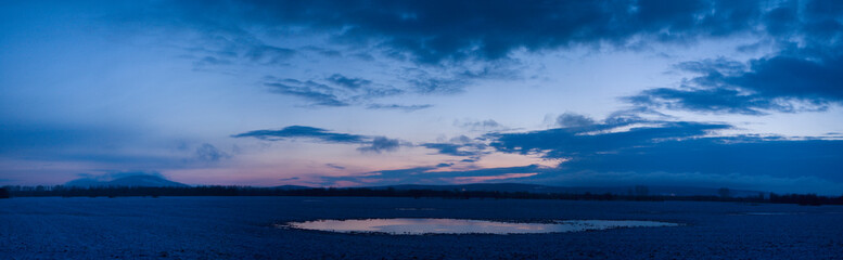 Fototapeta na wymiar Southern Urals, panorama of the spring field near Kushtau Mount, early morning.