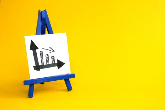 On a yellow background stands a miniature easel with a sheet of paper and a graph drawn on it.