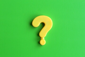  A yellow question mark lies on a green background.