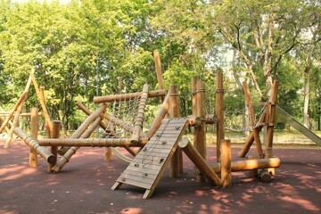 Wooden modern ecological safety children outdoor playground equipment in public park. Nature...