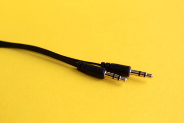 The connector for gadgets lies on a yellow background.