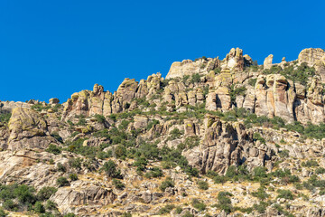 Rock face and stone formation on side of sunlit mountain in late afternoon sun in the great outdoors desert in arizona