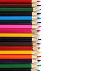 Bright colored pencils lie on a white background with space for text.