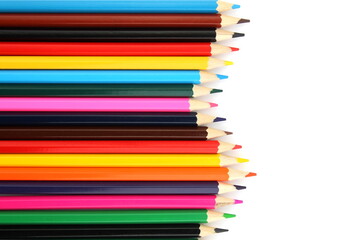 Bright colored pencils lie on a white background with space for text.