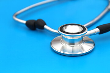the stethoscope lies on a blue background. The topic is medicine.	