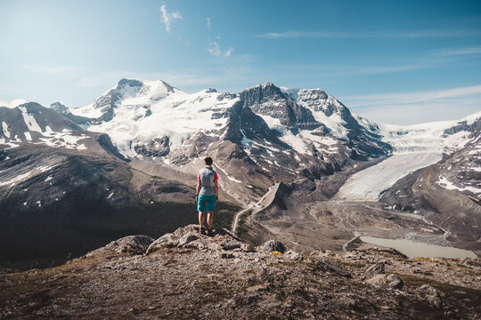 Hiker admiring scenic mountains, Alberta, Canada