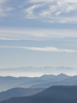 Elevated view across mountain ranges and clouds, winter
