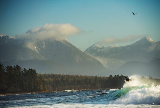 Surfer boosts air in mountains