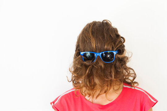 Woman with sunglasses over hair pulled over face