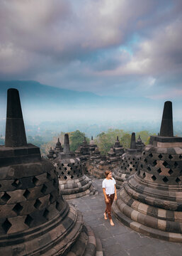 Woman walking among stupas at Borobudur temple, Magelang, Central Java, Indonesia