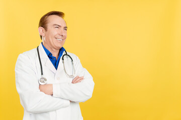 Mature doctor looking aside distracted with arms crossed