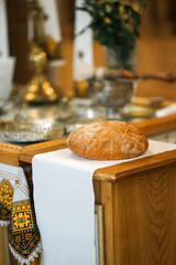 Bread on a white towel in the church during the wedding ceremony.