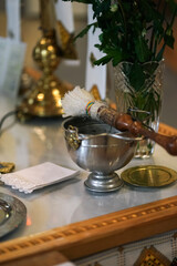 Holy water and drops lie on the throne in the church.