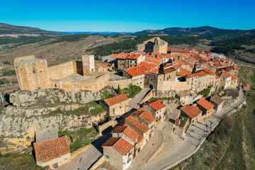 Fototapeta na wymiar Aerial fly over above the beautiful village of Puertomingalvo in the mountains of Aragon in Teruel Province Spain
