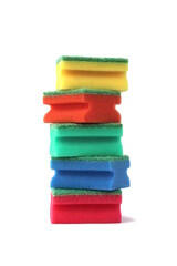 Many bright multi-colored sponges for washing dishes lie on a white background.