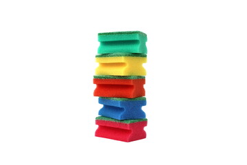 Many bright multi-colored sponges for washing dishes lie on a white background