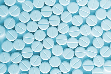 Abstract background of white pills on a blue background.