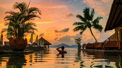 young men at a swimming pool at a luxury hotel, a Luxury swimming pool in a tropical resort,...