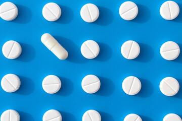 Abstract background of white pills on a blue background.