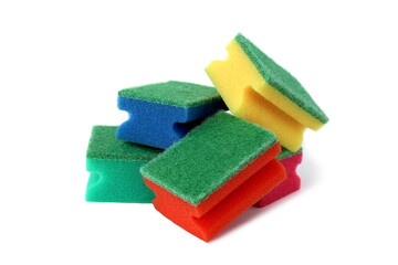 Many bright multi-colored sponges for washing dishes lie on a white background.