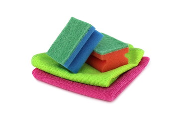 On a white background lie sponges and rags of bright different colors for cleaning housing.