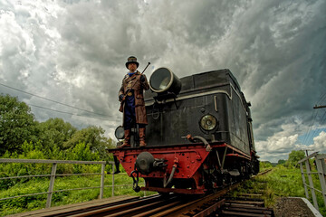 Fototapeta na wymiar The driver and his old steam train