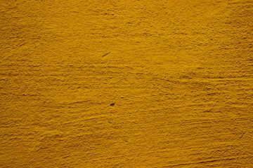 Yellow colored abstract wall background with textures of different shades of gold or yellow