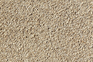 Texture of a stone wall of very small pebbles. Part of a stone wall, for background or texture.