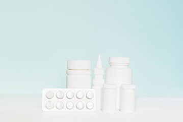 Set of different white  bottle mockup on blue background, pill bottles without label design, copy space	