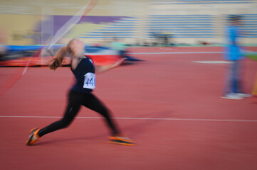 Unrecognized athlete doing javelin  spear throw in a sport competition. Javelin thrower at stadium