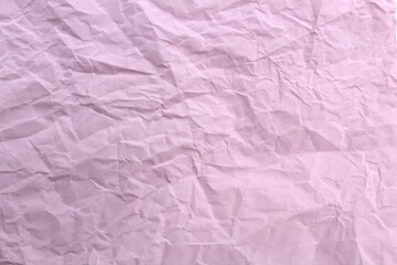 Soft crumpled sheet of light-colored paper. Abstract texture.