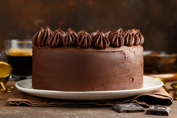 Chocolate  cake on a plate on a dark background. Delicious festive dessert. Selective focus
