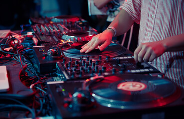 Hip hop dj scratching vinyl record on turntable. Close up photo of club disc jockey mixing records on a party