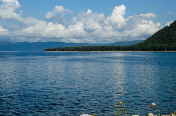 Bay on Lake Baikal in quiet sunny weather. Drawing of currents on the water.