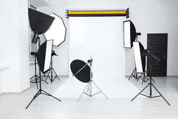 Interior of modern photo studio with professional lighting equipment