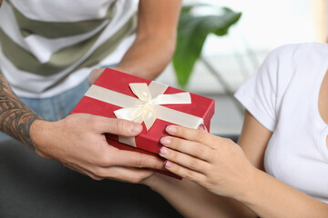 Lovely couple with beautiful gift, closeup view