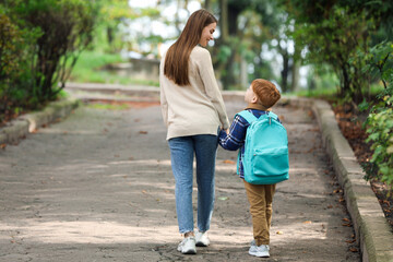 Obraz premium Young mom taking her son to school