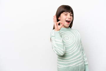 Little caucasian girl isolated on white background showing ok sign with fingers