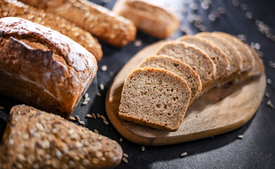 Assorted bakery products including loaves of bread and rolls