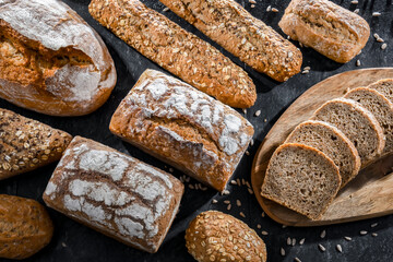 Assorted bakery products including loaves of bread and rolls