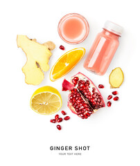 Ginger shot bottle and fresh fruits creative layout isolated on white.