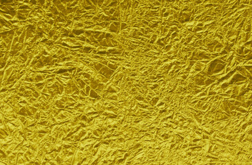 A thin wrinkled sheet of foil with a shiny crumpled surface for texture.