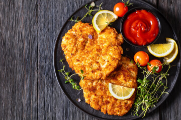 fried breaded chicken breast cutlets on plate