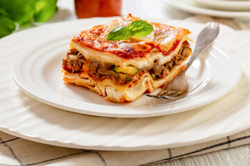 portion of Lasagna on white plate, top view