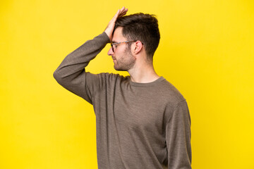 Young caucasian man isolated on yellow background has realized something and intending the solution